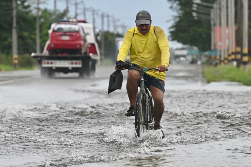 Un hombre viaja por la carretera inundada de Jujan Babahoyo luego de las fuertes lluvias en Jujan, provincia de Guayas, Ecuador, el 12 de marzo de 2025. (Marcos Pin/AFP vía Getty Images)