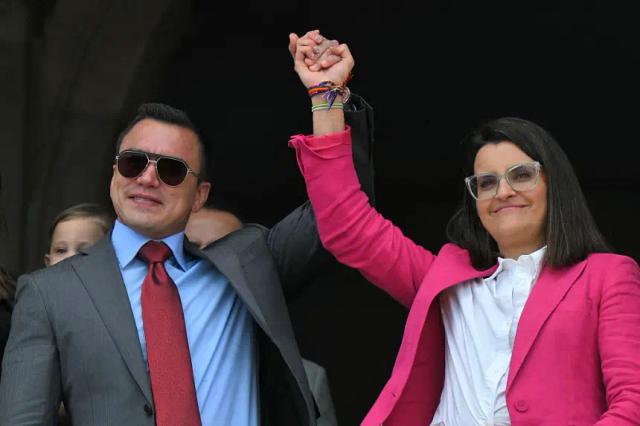 El presidente reelecto de Ecuador, Daniel Noboa, y la vicepresidenta reelecta, María José Pinto, se toman de la mano desde un balcón del Palacio Presidencial de Carondelet durante la ceremonia de cambio de guardia en Quito (Ecuador) el 15 de abril de 2025. (Rodrigo Buendia/AFP vía Getty Images)