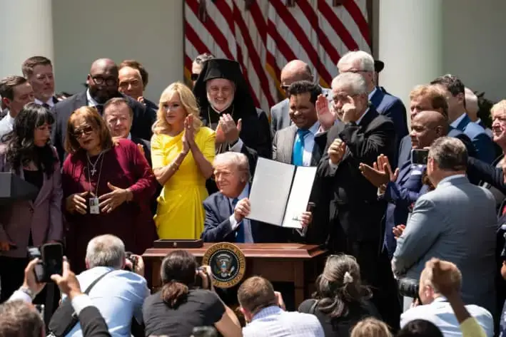 El presidente Donald Trump firma una orden ejecutiva para establecer la Comisión de Libertad Religiosa durante el evento del Día Nacional de Oración en el Jardín de Rosas de la Casa Blanca, el 1 de mayo de 2025. (Madalina Vasiliu/The Epoch Times)