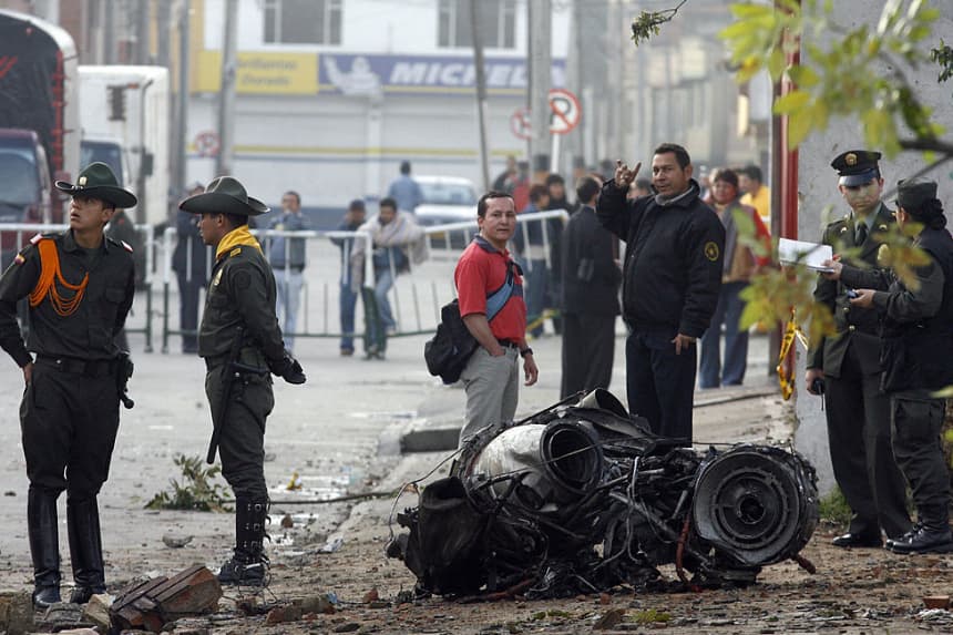 Policías colombianos y miembros de la Fuerza Aérea trabajan junto a los restos de un avión que se estrelló cerca del aeropuerto El Dorado el 12 de octubre de 2007 en Bogotá. (Rodrigo Arangua/AFP vía Getty Images)