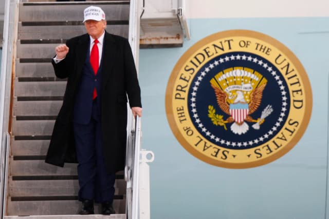 El presidente Donald Trump levanta el puño al bajar del Air Force One a su llegada al Aeropuerto Internacional de Calgary, antes del inicio de la cumbre del G7, en Calgary, Alberta (Canadá), el 15 de junio de 2025. (Dave Chidley/AFP a través de Getty Images)