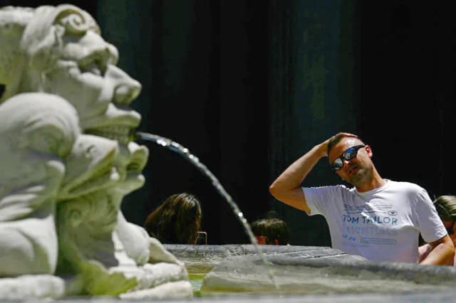 Un hombre se refresca en una fuente cerca del Panteón durante un caluroso día de verano en Roma (Italia), el 26 de junio de 2025. (Filippo Monteforte/AFP vía Getty Images)