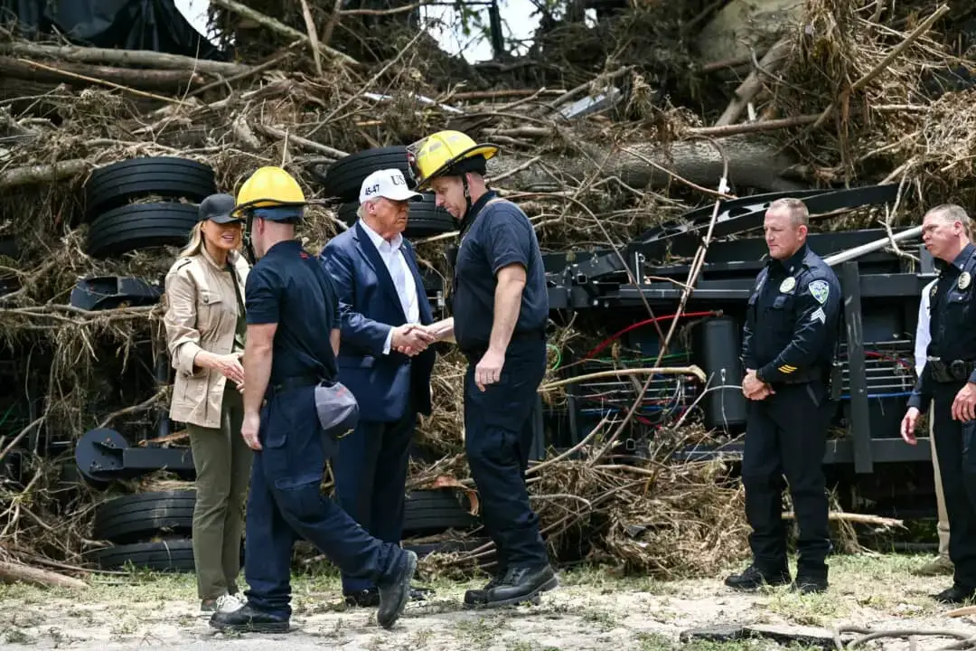 El presidente Donald Trump y la primera dama Melania Trump saludan a los equipos de primera respuesta cerca del río Guadalupe tras las devastadoras inundaciones que se produjeron en la zona durante el fin de semana del 4 de julio, en Kerrville, Texas, el 11 de julio de 2025. (Brendan Smialowski/AFP a través de Getty Images)