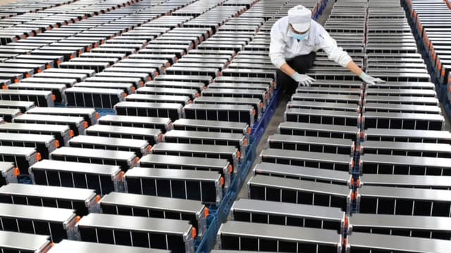 Un trabajador con baterías de coche en Nanjing, China, el 12 de marzo de 2021. (STR/AFP a través de Getty Images)
