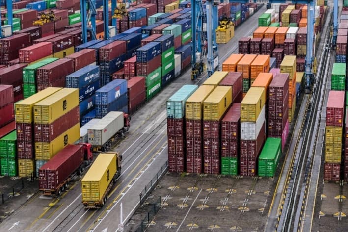 Un camión pasa junto a contenedores en el puerto de Ningbo-Zhoushan en Ningbo, en la provincia oriental china de Zhejiang, el 28 de mayo de 2025. (Hector RETAMAL/AFP vía Getty Images)