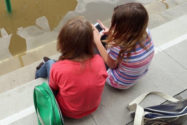 Dos chicas hablan sobre las aplicaciones en sus teléfonos. (Sean Gallup/Getty Images)