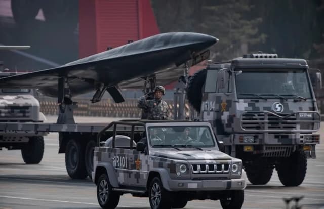 Un soldado chino saluda frente a un dron militar durante un desfile para celebrar el 70.° aniversario de la fundación del régimen comunista chino en la plaza de Tiananmen, en Beijing, el 1 de octubre de 2019. (Kevin Frayer/Getty Images)