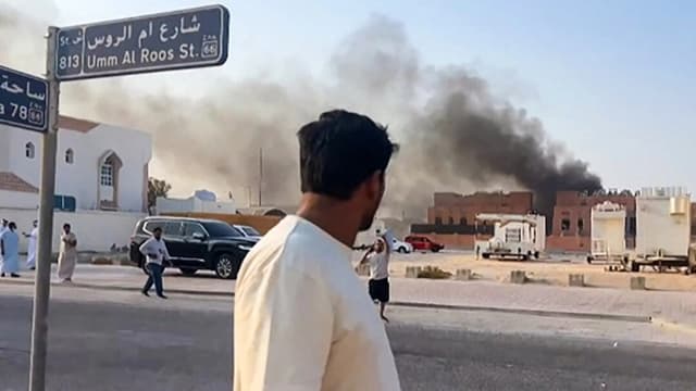 Un hombre observa el humo que se eleva tras las explosiones en Doha, capital de Catar, el 9 de septiembre de 2025, en esta imagen tomada de un vídeo de AFPTV. (Jacqueline Penney /AFPTV/AFP a través de Getty Images)
