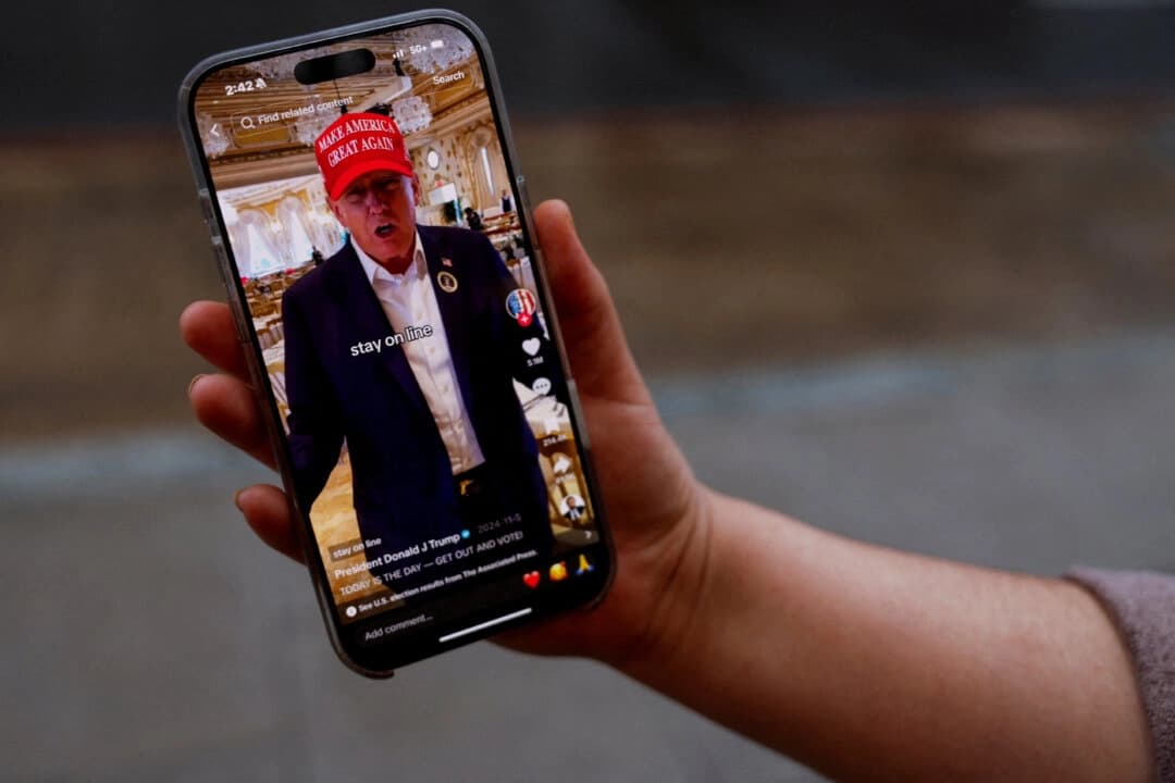 Una mujer posa con su smartphone mostrando la página de TikTok @realdonaldtrump, en Washington, el 19 de enero de 2025. (Shannon Stapleton/Reuters)

