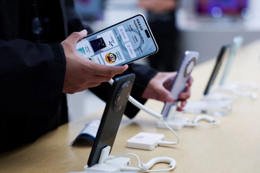 Una persona revisa un teléfono inteligente Huawei Mate 60 Pro exhibido en una tienda insignia de Huawei en Beijíng el 25 de septiembre de 2023. (Florence Lo/Reuters)