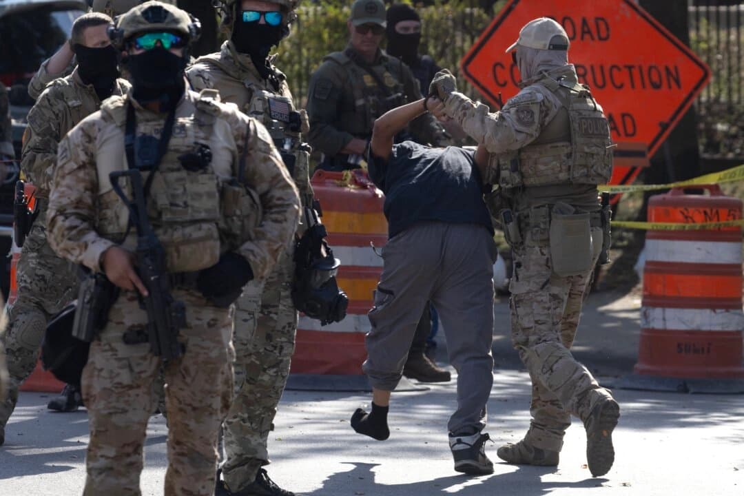 La policía detiene a un hombre mientras miembros de la comunidad y activistas se enfrentan a agentes federales en Broadview, Illinois, el 4 de octubre de 2025. (Scott Olson/Getty Images)