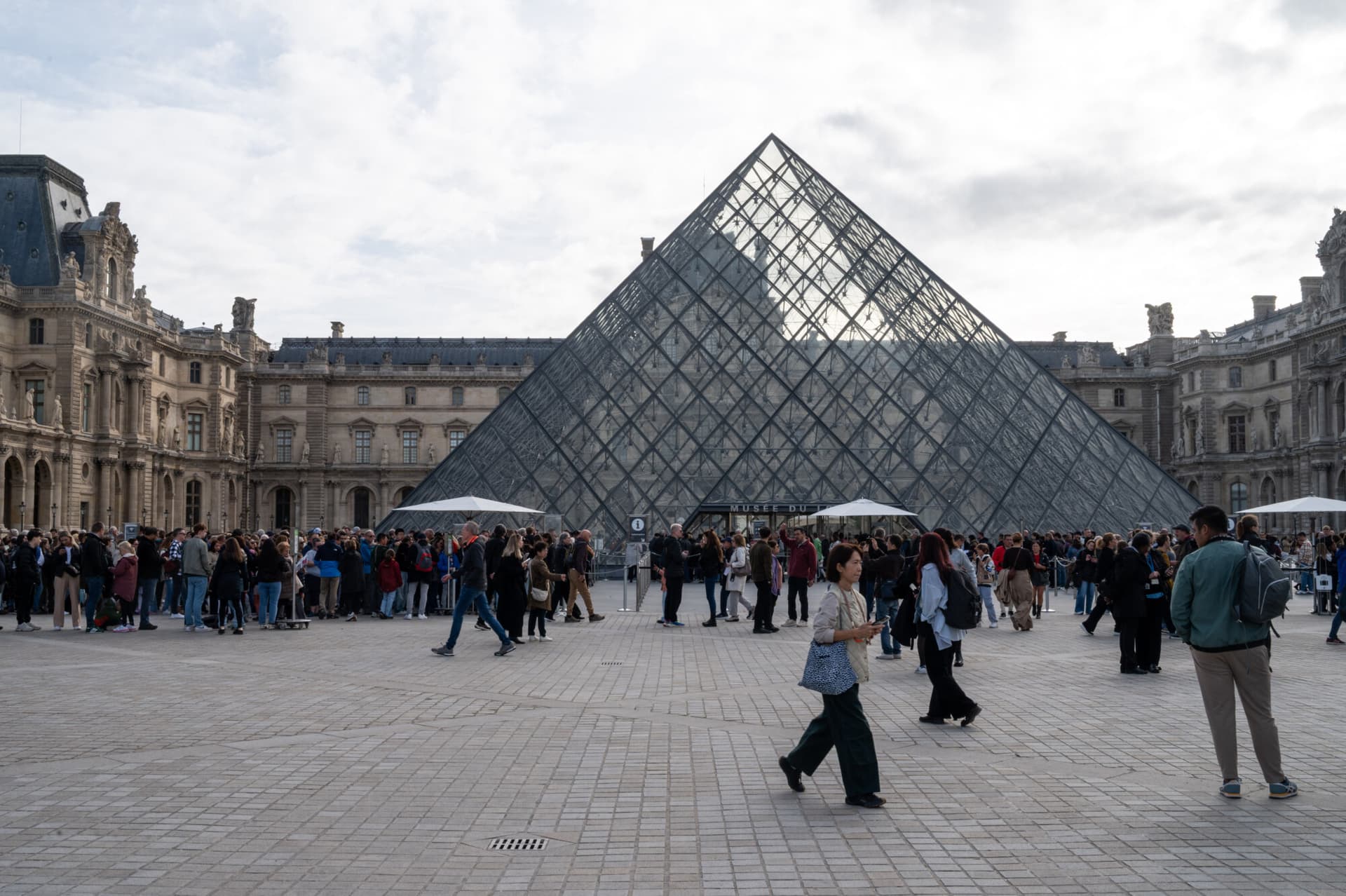 En el patio Napoleón, con la pirámide del Louvre en el centro, varios visitantes hacen cola para entrar en el Museo del Louvre tras su reapertura tras el robo de varias joyas el 19 de octubre en París, Francia, el 22 de octubre de 2025. El Museo del Louvre reabrió sus puertas el 22 de octubre tras tres días de cierre, a raíz del robo del que fue víctima. El museo reabre sus puertas este miércoles, con la excepción de la Galería de Apolo. (Foto de Riccardo Milani / Hans Lucas vía AFP) (Foto de RICCARDO MILANI/Hans Lucas/AFP vía Getty Images).