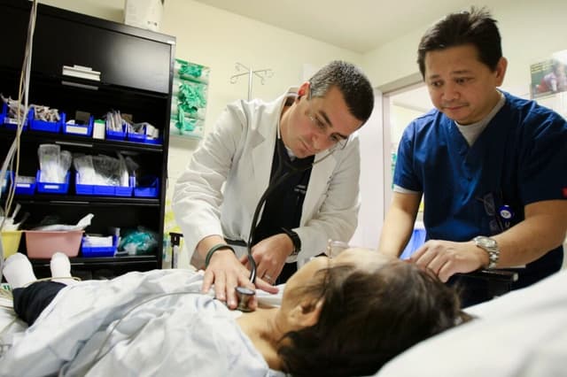 Un médico y una enfermera de urgencias atienden a un paciente en el Hospital Comunitario Mission de Panorama City, California, el 28 de enero de 2009. (David McNew/Getty Images)