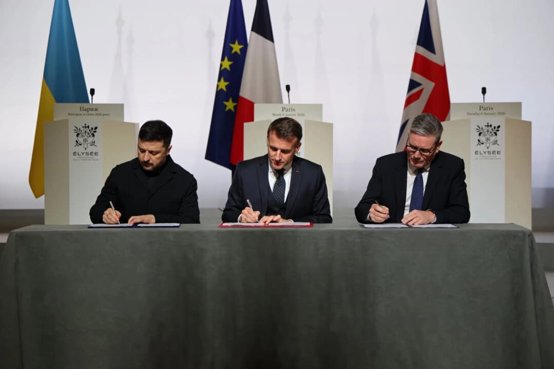 El presidente ucraniano, Volodímir Zelenski, el presidente francés, Emmanuel Macron, y el primer ministro británico, Keir Starmer, firman una declaración sobre el despliegue de una fuerza posterior al alto el fuego en Ucrania, en el Palacio del Elíseo en París el 6 de enero de 2026. (Ludovic Marin, foto de Pool vía AP)