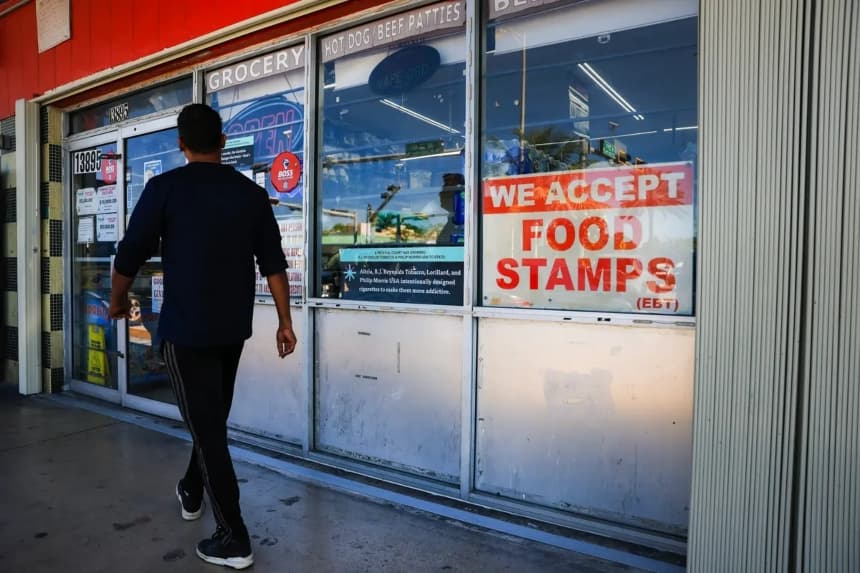 A 'We Accept Food Stamps' sign hangs in the window of a grocery store on October 31, 2025 in Miami, Florida. The food stamp program, now known as the Supplemental Nutrition Assistance Program (SNAP), may run out of funding on November 1st due to the federal government shutdown, which is now entering its second month. In Miami-Dade County, nearly one in six residents receives food assistance. (Photo by Joe Raedle/Getty Images)