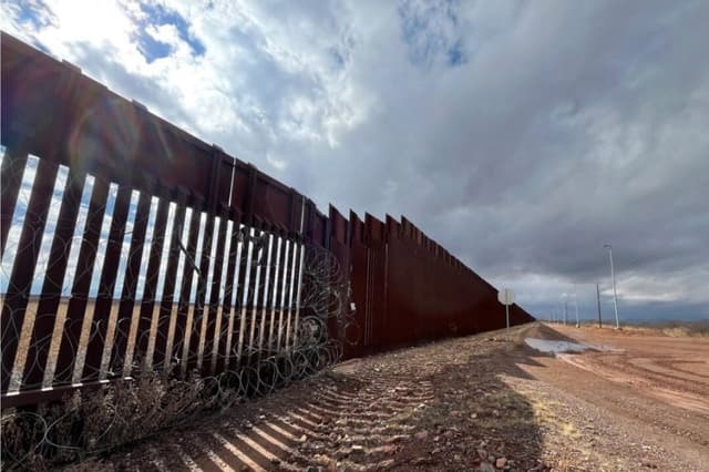 Una valla de seguridad de 5,5 metros de altura se une a una valla de bolardos de acero de 9 metros construida durante el primer mandato del presidente Donald Trump en Douglas, Arizona, el 22 de enero de 2026. Allan Stein/The Epoch Times