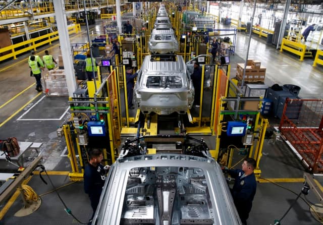 Workers assemble cars at the newly renovated Ford's Assembly Plant in Chicago, June 24, 2019. - The plant was revamped to build the Ford Explorer, Police Interceptor Utility and Lincoln Aviator. (Photo by JIM YOUNG / AFP)        (Photo credit should read JIM YOUNG/AFP via Getty Images)