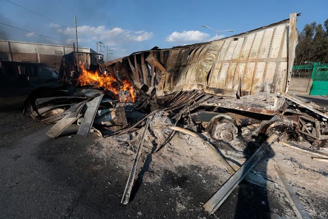 Vista de un camión en llamas, presuntamente incendiado por grupos del crimen organizado en respuesta a un operativo para detener a un objetivo de seguridad de alta prioridad, en una carretera cerca de Acatlán de Juárez, estado de Jalisco, México, el 22 de febrero de 2026. (Ulises Ruiz/AFP vía Getty Images)