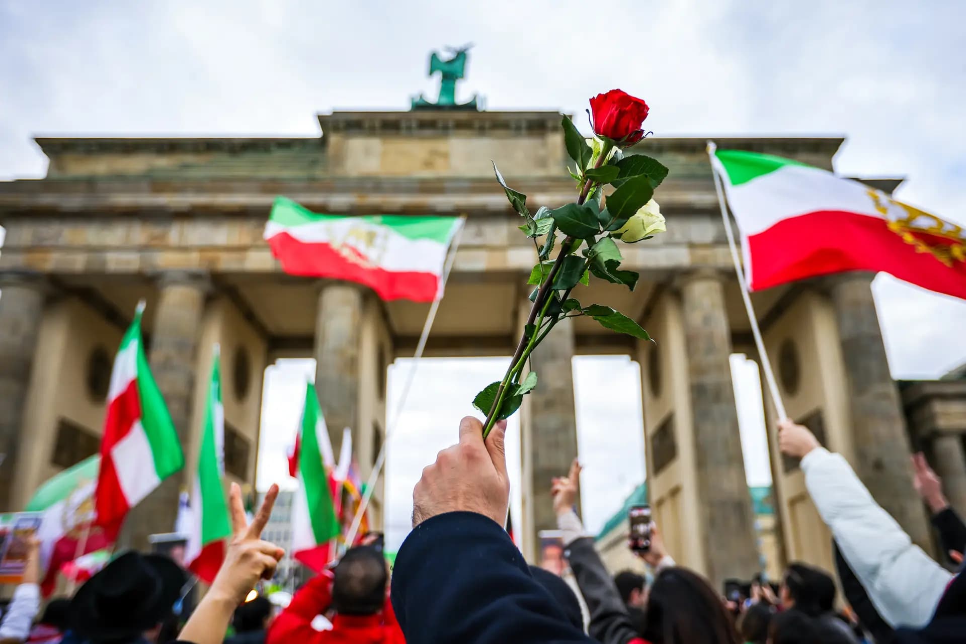 La gente, muchos de ellos iraníes expatriados que viven en Berlín, enarbolan banderas y rosas mientras se reúnen para celebrar el Nowruz, el año nuevo persa, en Berlín el 20 de marzo de 2026. (Omer Messinger/Getty Images).