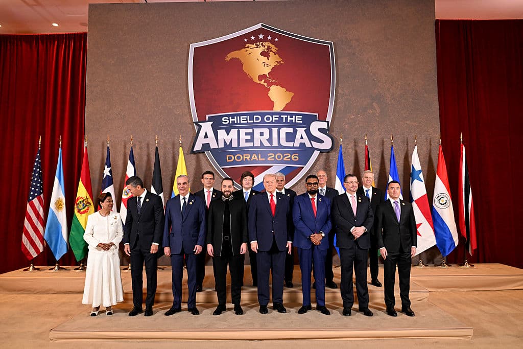 <em>El presidente de Estados Unidos, Donald Trump (C), junto a (de izquierda a derecha) Kamla Persad-Bissessar, SC, MP, primer ministro de la República de Trinidad y Tobago, Santiago Peña, presidente de la República del Paraguay, Luis Abinader, presidente de la República Dominicana, Rodrigo Paz Pereira, presidente de Bolivia, Nayib Bukele, presidente de El Salvador, Javier Milei, presidente de Argentina, José Raúl Mulino, presidente de Panamá, Mohamed Irfaan Ali, presidente de Guyana, Nasry “Tito” Asfura, presidente de Honduras, Rodrigo Chaves Robles, presidente de Costa Rica, José Antonio Kast, presidente electo de Chile, y Daniel Roy Gilchrist Noboa Azín, presidente de Ecuador, durante una fotografía grupal al inicio de la “Cumbre El Escudo de las Américas”, una reunión con jefes de estado y funcionarios de gobierno de 12 países de las Américas en el Trump National Doral Golf Club el 7 de marzo de 2026. en Doral, Florida. La Casa Blanca describe la reunión como una cumbre histórica destinada a reconfigurar las alianzas regionales y reforzar la influencia de Estados Unidos en el hemisferio occidental. (Foto de Roberto Schmidt/Getty Images)</em>