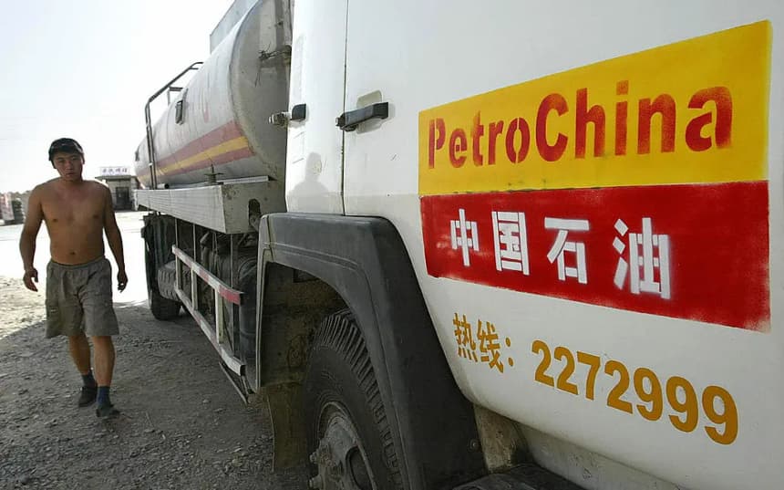 Un hombre camina junto a un camión cisterna de PetroChina. (Frederic J. Brown/AFP vía Getty Images)