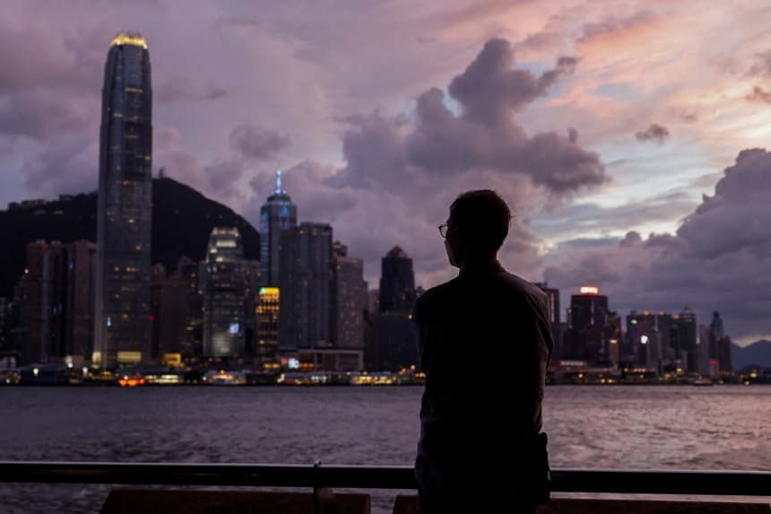 Un hombre se encuentra de pie frente al puerto de Victoria, con el distrito financiero Central al fondo, en Hong Kong, China, el 5 de septiembre de 2024. (Tyrone Siu/Reuters)