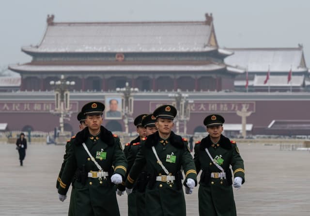 Miembros de la Policía Armada del Pueblo marchan frente a un retrato del exlíder chino Mao Zedong en la Plaza de Tiananmen en Beijing el 5 de marzo de 2026. Kevin Frayer/Getty Imágenes