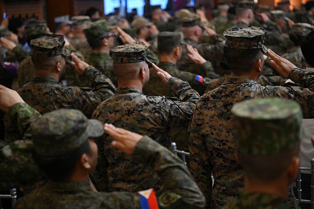 Soldados estadounidenses y filipinos saludan mientras suenan sus himnos nacionales durante la ceremonia de inauguración de las maniobras militares conjuntas anuales «Balikatan» entre Estados Unidos y Filipinas, celebradas en el campamento Aguinaldo de Manila el 21 de abril de 2025. (Foto de Ted ALJIBE / AFP) (Foto de TED ALJIBE/AFP vía Getty Images)