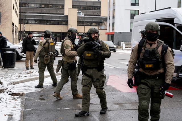 Agentes del sheriff del condado de Hennepin llegan al centro de Minneapolis para rescatar a un hombre atacado por manifestantes anti-ICE cerca del ayuntamiento, el 17 de enero de 2026 en Minnesota. (ROBERTO SCHMIDT / AFP vía Getty Images).