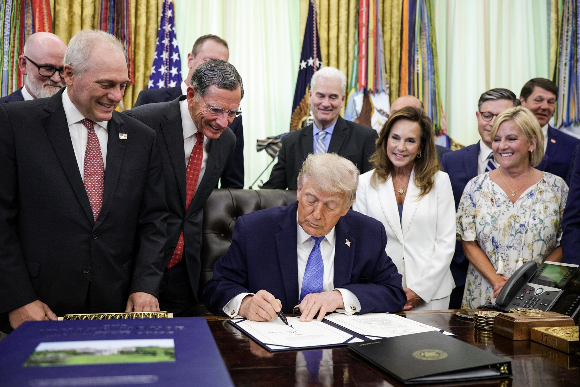 Los miembros del Congreso observan cómo el presidente Donald Trump firma la Ley "Secure America" en el Despacho Oval el 10 de junio de 2026. Este paquete de 72 mil millones de dólares financia las operaciones de la Patrulla Fronteriza y del Servicio de Inmigración y Control de Aduanas (ICE) hasta el final del mandato de Trump, en el año fiscal 2029. (Alex Wong/Getty Images).