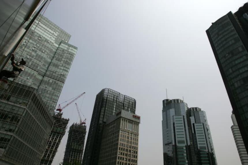 Un obrero trabaja en el distrito central de negocios (CBD) de rápido desarrollo en Beijing el 14 de junio de 2007. El área alberga unas 3,000 empresas, incluidas multinacionales y firmas extranjeras. (Guang Niu/Getty Images).