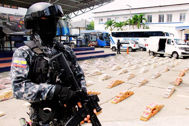 Un agente de la policía ecuatoriana monta guardia de una tonelada de drogas incautadas en diversas operaciones, en los patios del cuartel Modelo en Guayaquil, Ecuador, el 23 de enero de 2026. (Gerardo MENOSCAL / AFP vía Getty Images)