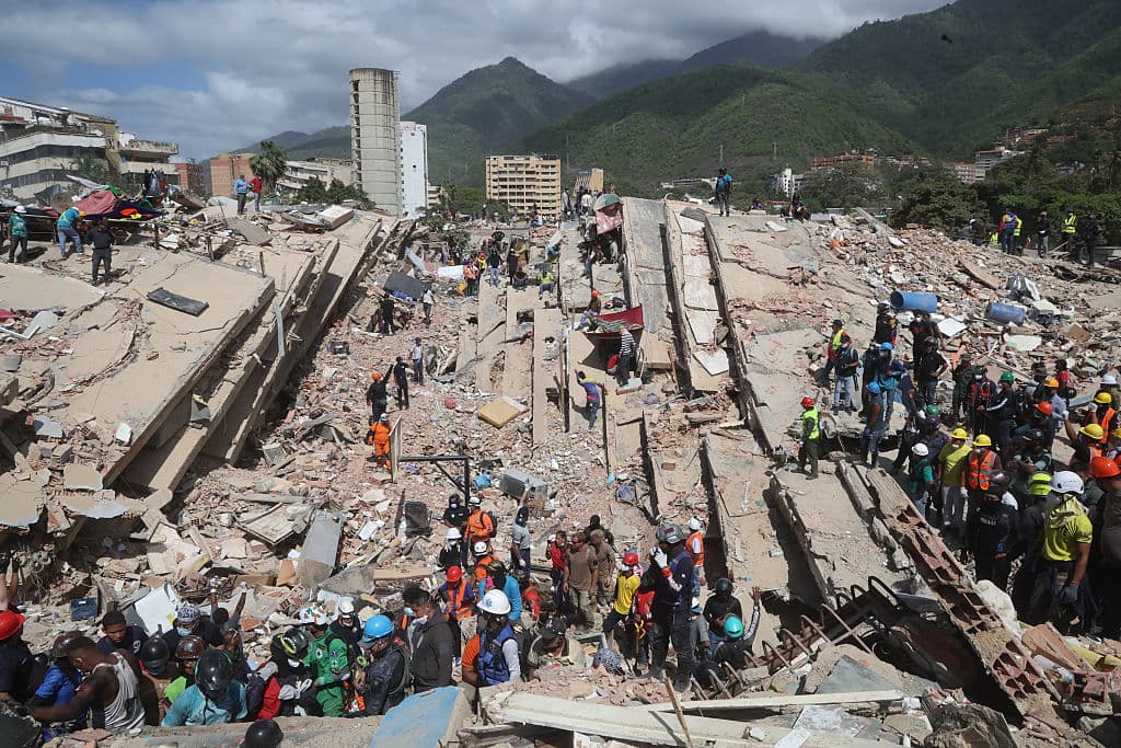 <em>Rescatistas continúan la búsqueda y rescate entre escombros de edificios derrumbados en la playa de Los Cocos después de que un terremoto de magnitud 7,2 sacudiera Venezuela y otras regiones del Caribe el 29 de junio de 2026 en La Guaira, Venezuela. Según el Servicio Geológico de Estados Unidos (USGS), al terremoto principal le siguió una réplica de magnitud 7,5 menos de un minuto después. El número de víctimas mortales aumentó a más de 1.400, mientras que el número de heridos superó los 3000. Más de 70,000 personas están desaparecidas. (Edilzón Gámez/Getty Images)</em>
