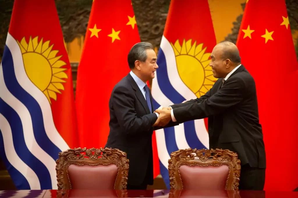 El ministro de Relaciones Exteriores de China, Wang Yi (izquierda), y el presidente de Kiribati, Taneti Maamau, se dan la mano durante una ceremonia de firma en el Gran Salón del Pueblo en Beijing el 6 de enero de 2020. (Mark Schiefelbein/Pool/AFP vía Getty Images)