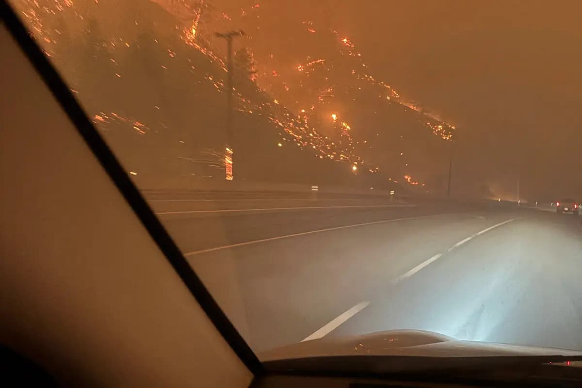 <em>La ladera arde después de la medianoche mientras los residentes evacuan hacia Kelowna debido al incendio forestal de Bald Range a lo largo de la autopista 97 cerca de Summerland, Columbia Británica, el 8 de agosto de 2026. (Terry Fries/Imagen cedida a través de Reuters).</em>
