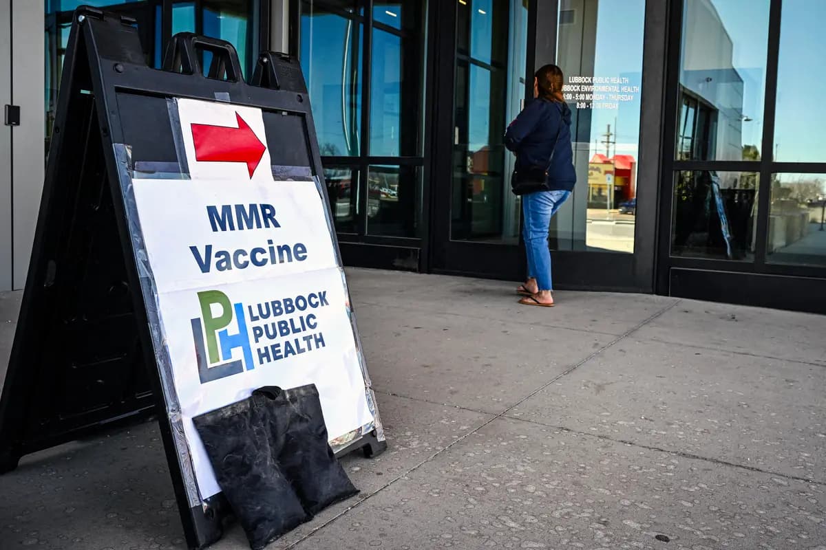 Una persona pasa junto a un cartel en un centro de salud donde se administra la vacuna contra el sarampión, las paperas y la rubéola (MMR) en Lubbock, Texas, el 27 de febrero de 2025. (Ronald Schemidt/AFP vía Getty Images).