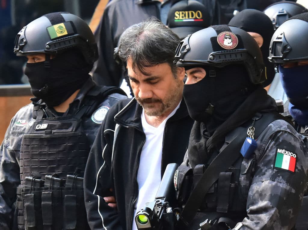 <em>Agentes de la Agencia de Investigación Criminal y soldados del ejército mexicano escoltan a Dámaso López, alias "el Licenciado", tras su detención en la Ciudad de México el 2 de mayo de 2017. López era señalado como uno de los principales operadores de Joaquín "el Chapo" Guzmán y como participante en la disputa violenta por el control del Cártel de Sinaloa (STR / AFP vía Getty Images)</em>