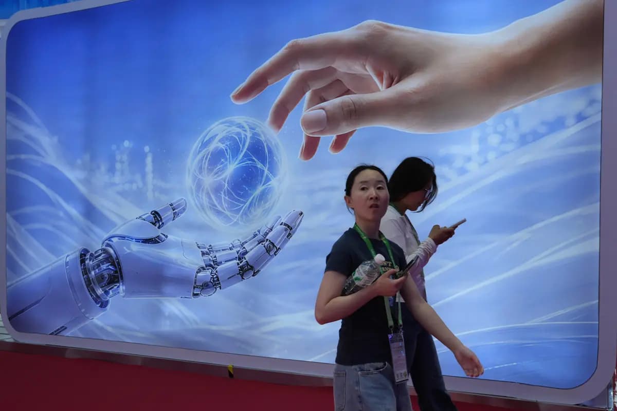 <em>Visitantes pasan junto a una exhibición que representa inteligencia artificial y una mano humana en la Exposición Internacional de la Cadena de Suministro de China en Beijing, el 22 de junio de 2026. (Ng Han Guan/AP).</em>