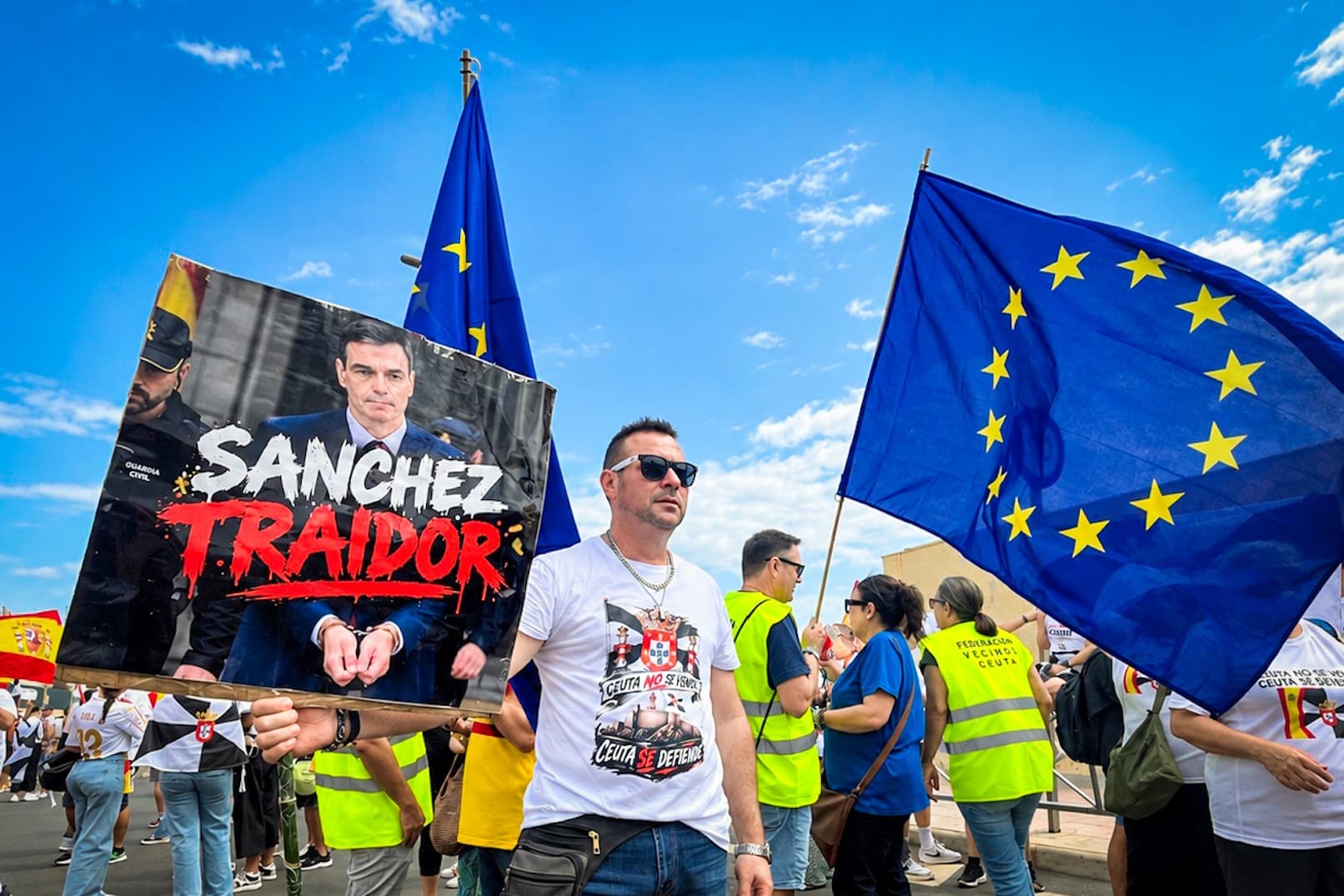Un manifestante sostiene un cartel que califica de «traidor» al presidente del Gobierno español, Pedro Sánchez, durante una marcha en Ceuta, mientras más de 1.000 residentes se dirigen a pie a la frontera del Tarajal para exigir la expulsión de inmigrantes ilegales y reafirmar que la ciudad es española y europea. (Etienne Fauchaire/The Epoch Times).