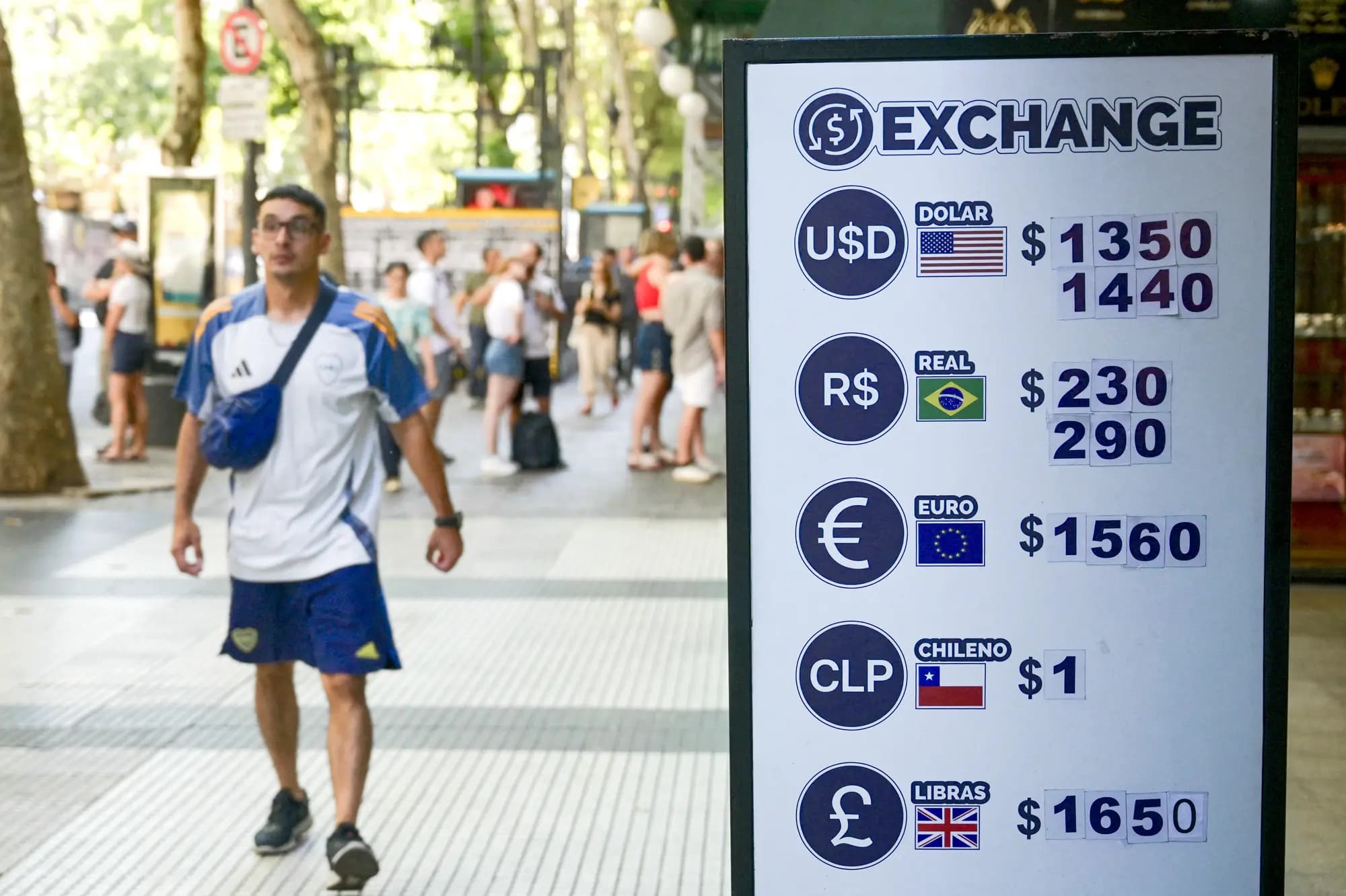 <em>Un hombre pasa junto a un panel de cambio de divisas que muestra los valores de monedas internacionales en pesos argentinos, frente a una tienda en Buenos Aires el 18 de febrero de 2026. (Juan Mabromata/AFP vía Getty Images).</em>