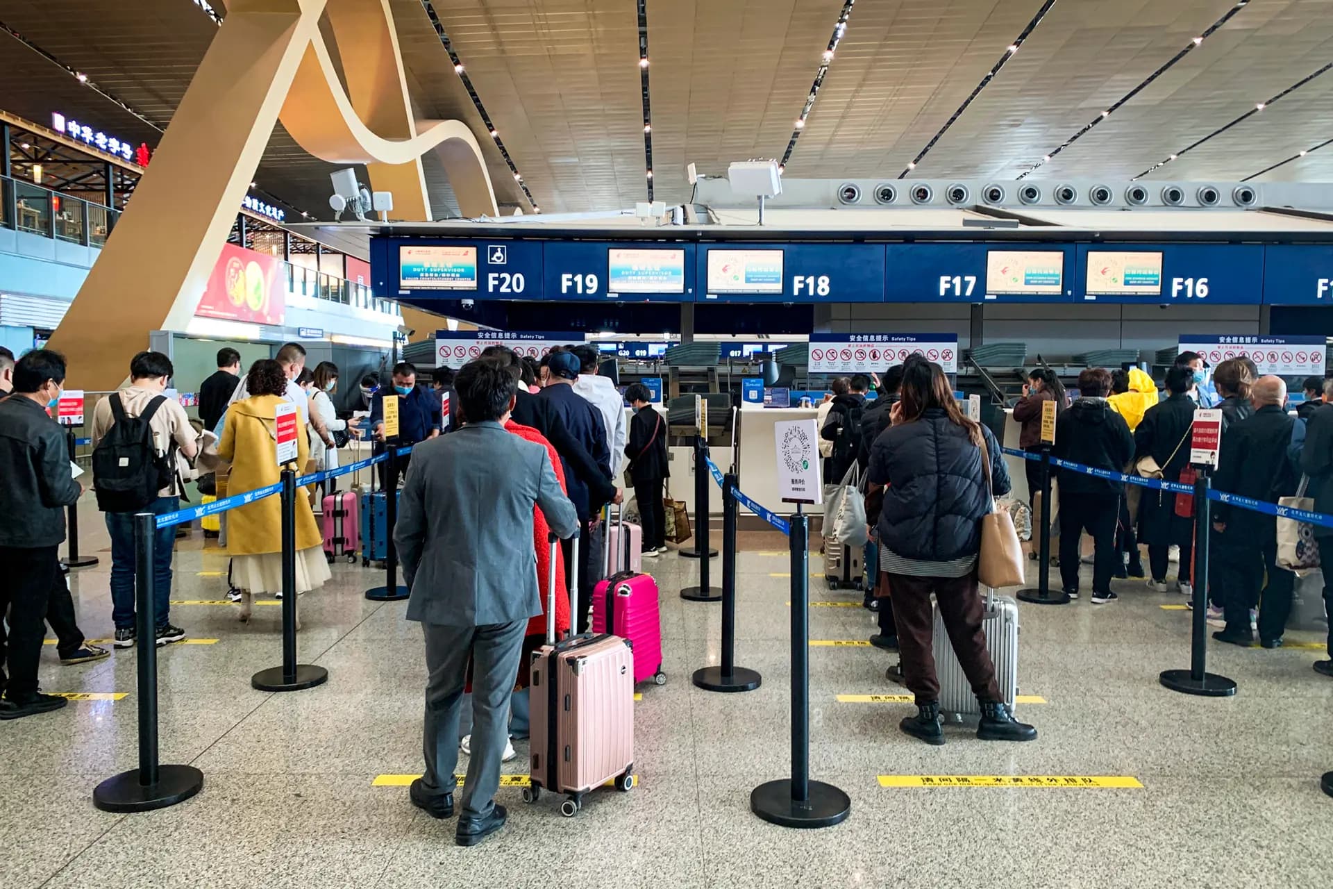Los viajeros hacen cola en el mostrador de facturación de China Eastern Airlines en el Aeropuerto Internacional de Kunming Changshui, en Kunming, provincia de Yunnan (China), el 22 de marzo de 2022. (Dake Kang/AP Photo)