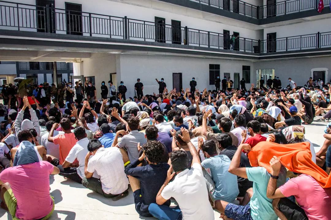 <em>Trabajadores de un centro de estafas, muchos de los cuales fueron víctimas de trata y obligados a trabajar para delincuentes, son custodiados por tropas de la Guardia Fronteriza Karen en Myawaddy, Birmania, el 26 de febrero de 2025. (Stringer/Reuters).</em>