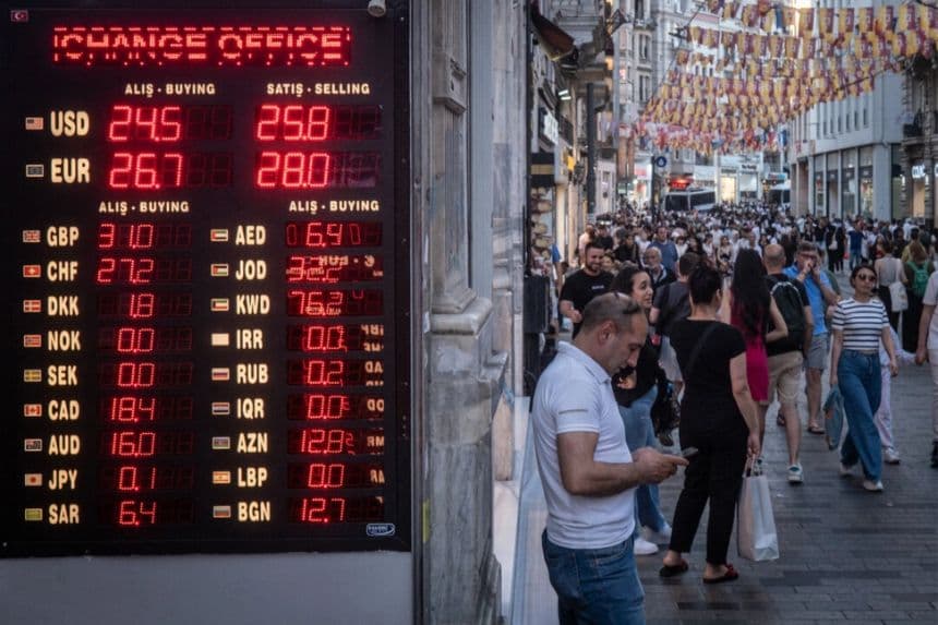 Un grupo de personas pasa por delante de una tienda de cambio de divisas en Estambul el 23 de junio de 2023. (Chris McGrath/Getty Images)
