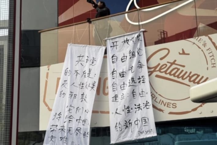 El 25 de octubre de 2025, justo después de la conclusión del Cuarto Pleno del XX Comité Central del PCCh, dos pancartas anti-PCCh aparecieron en una calle del distrito de Sanlitun de Beijing, denunciando al Partido como una "secta antihumana". (Captura de pantalla de las redes sociales de The Epoch Times)