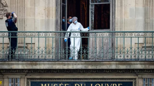 Un oficial forense francés examina una ventana rota en el balcón de la escena del crimen en el Louvre de París el 19 de octubre de 2025. (Kiran Ridley/Getty Images).