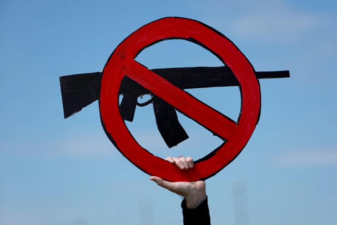 Un hombre sostiene un cartel durante la segunda manifestación de March for Our Lives contra la violencia con armas de fuego en Pine Trails Park, en Parkland, Florida, el 11 de junio de 2022. (Joe Raedle/Getty Images)
