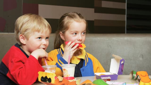 MELBOURNE, AUSTRALIA - 29 DE AGOSTO: Niños comiendo un nuevo Happy Meal en el restaurante McDonald's de Collingwood el 29 de agosto de 2006 en Melbourne, Australia. El nuevo Happy Meal es una alternativa baja en grasas al Happy Meal tradicional de la cadena de comida rápida. La obesidad infantil es un grave problema de salud en Australia y se ha triplicado en los últimos 20 años, hasta el punto de que uno de cada seis niños australianos está clasificado como obeso. (Foto de Kristian Dowling/Getty Images).