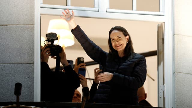 Nobel peace laureate Maria Corina Machado greets supporters from a balcony of the Grand Hotel in Oslo, Norway, early on December 11, 2025. Machado arrived in Oslo hours after the Venezuelan opposition leader's award was collected on her behalf by her daughter. (Photo by Odd ANDERSEN / AFP via Getty Images)