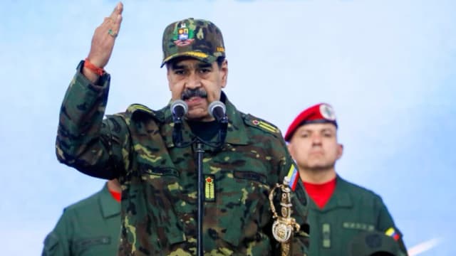 El presidente de Venezuela, Nicolás Maduro, sostiene la espada de Simón Bolívar mientras se dirige a miembros de las fuerzas armadas, la Milicia Bolivariana, la policía y civiles durante una manifestación contra una posible escalada de las acciones estadounidenses hacia el país, en la base militar de Fuerte Tiuna en Caracas, Venezuela, el 25 de noviembre de 2025. (REUTERS/Leonardo Fernández Viloria)