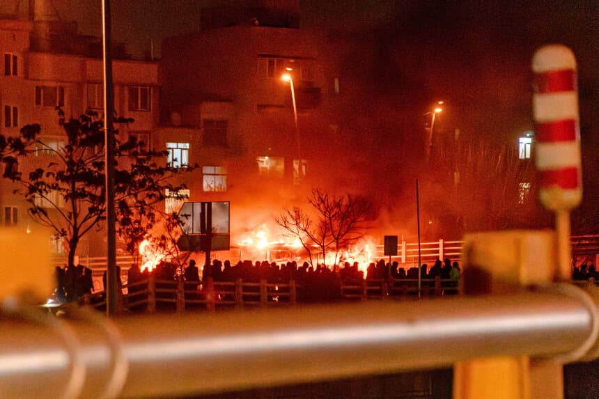 Iranians gather while blocking a street during a protest in Tehran, Iran on January 9, 2026. The nationwide protests started in Tehran's Grand Bazaar against the failing economic policies in late December, which spread to universities and other cities, and included economic slogans, to political and anti-government ones. (Photo by Khoshiran / Middle East Images / AFP via Getty Images)